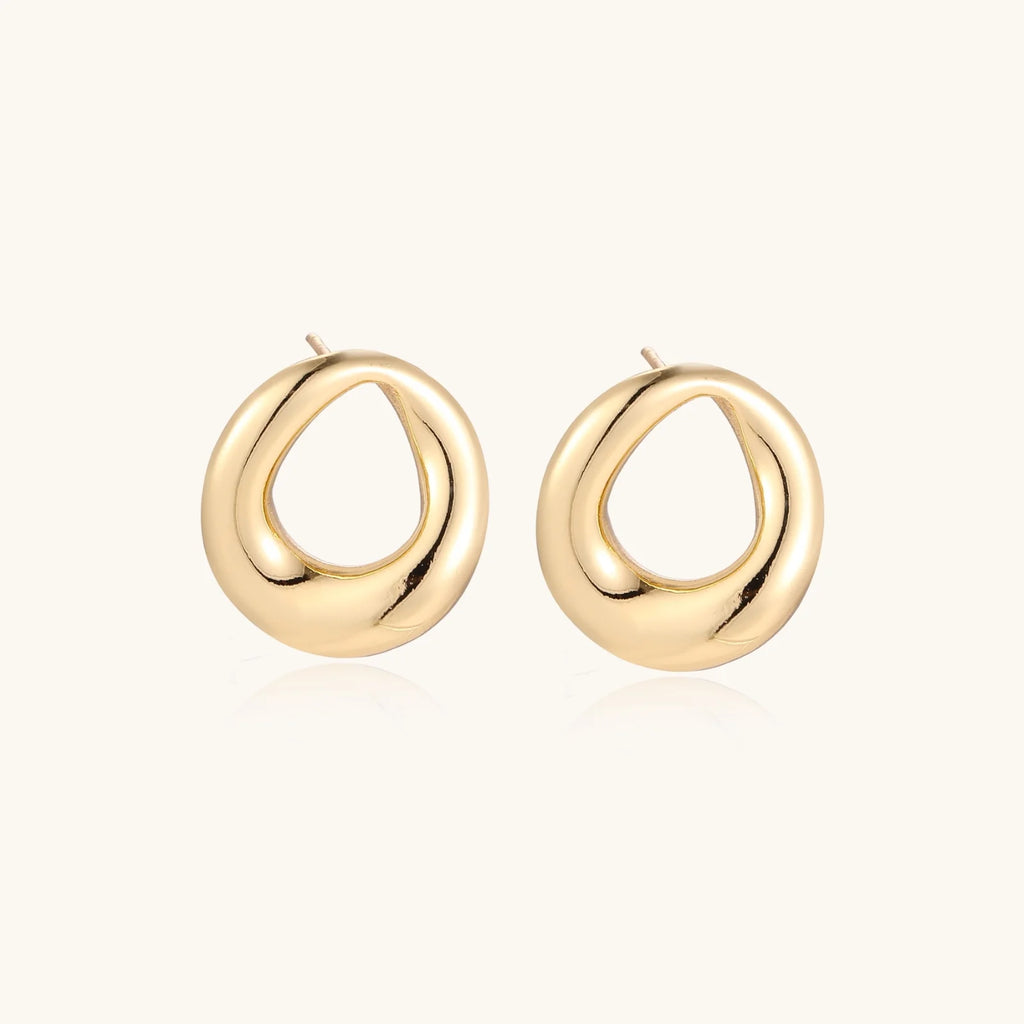 Pair of polished 18K gold-plated stainless steel teardrop earrings with hollow centers on cream background