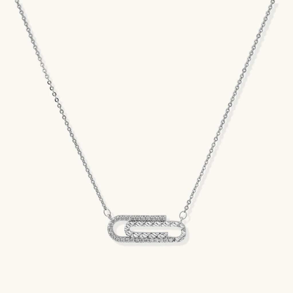 White gold plated necklace with dual-frame geometric pendant featuring crystal pavé border on pale background.